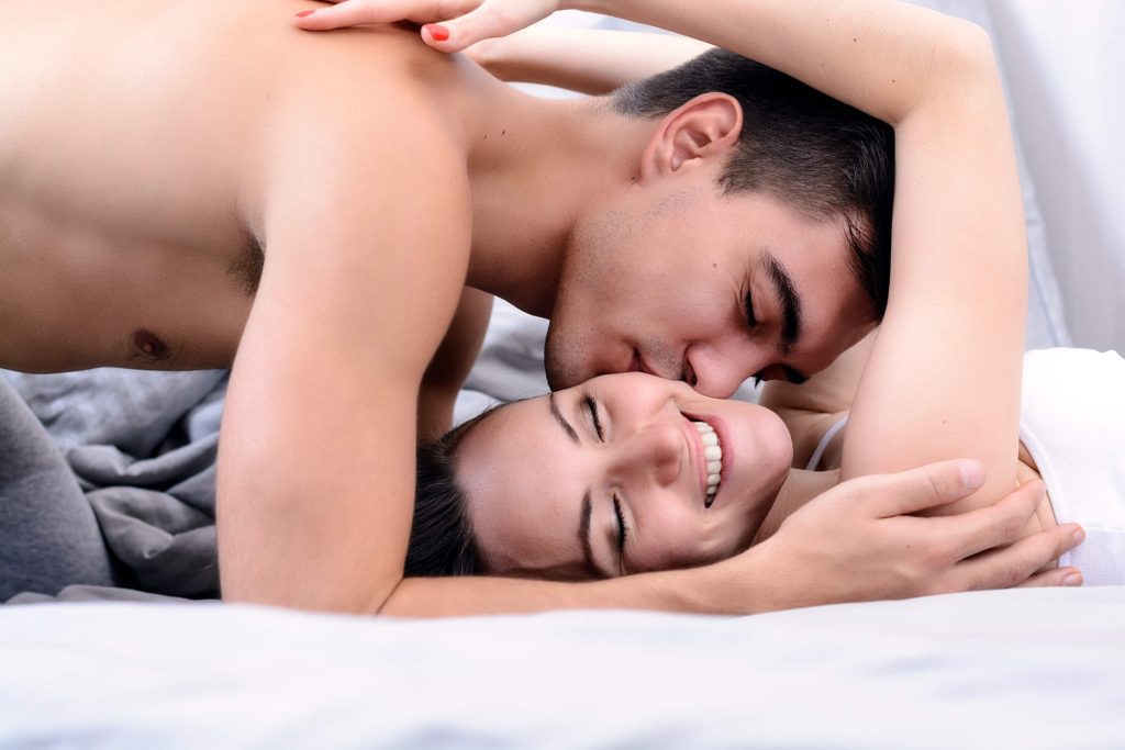 playful couple in bed