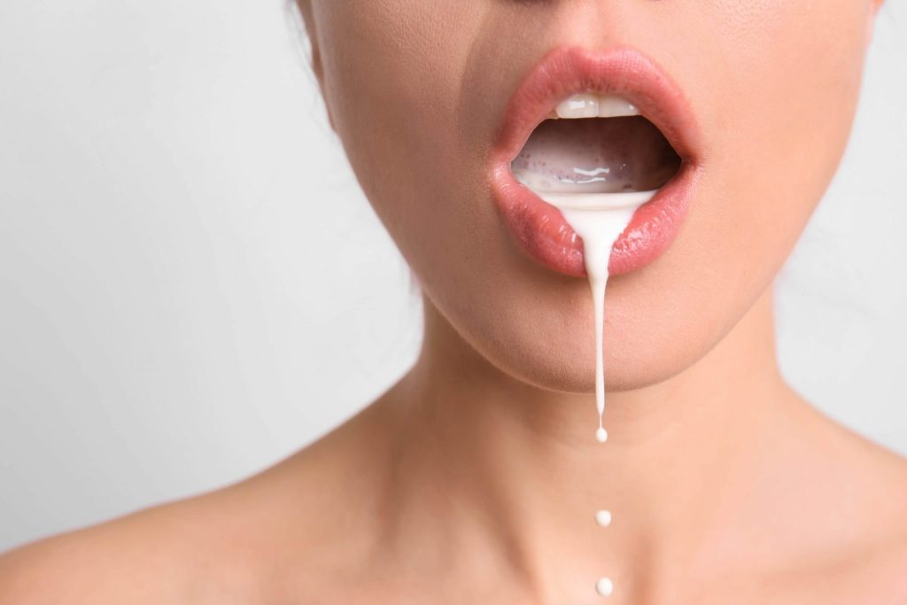 woman simulating cum in mouth