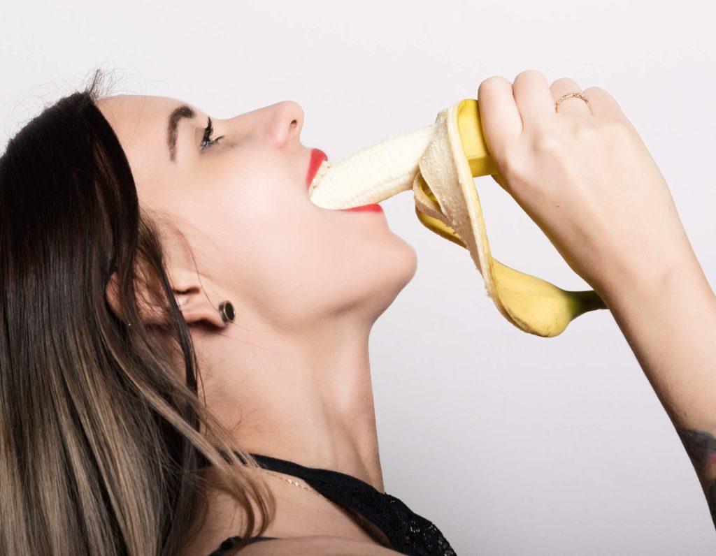 woman deep-throating a banana