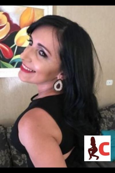 black haired Inverness escort smiling and modelling