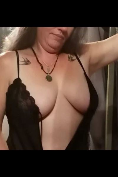 mature South Ayrshire escort with swallows tattooed on shoulders