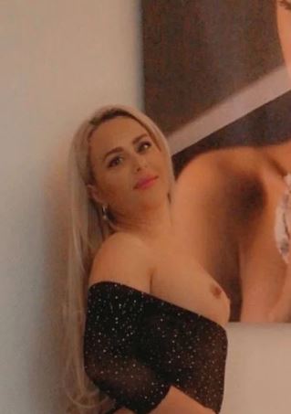 blonde St Andrews escort showing her tits