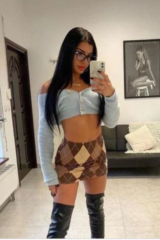 young sexy St Andrews escort in brown argyle mini skirt