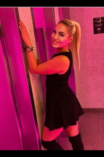 smiling blonde Dundee escort in the toilet