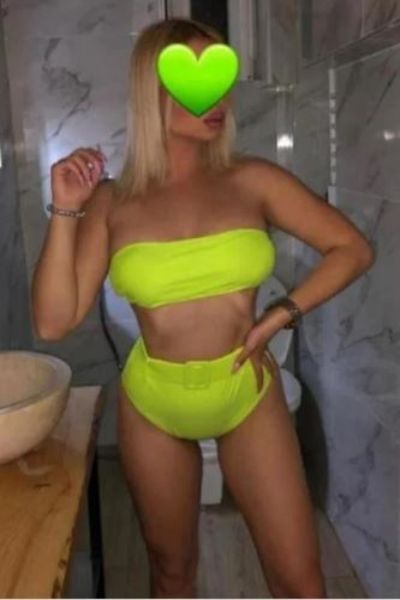 full pouty lipped Coventry escort in florescent yellow outfit