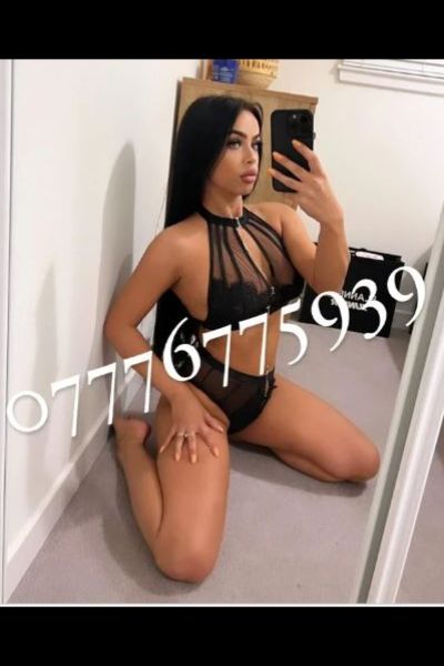 long dark haired Crawley escort kneeling