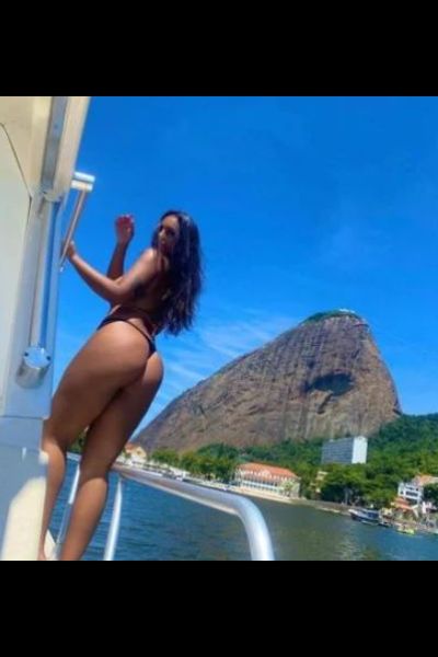 Brazilian Escort in Gloucester stood on a boat