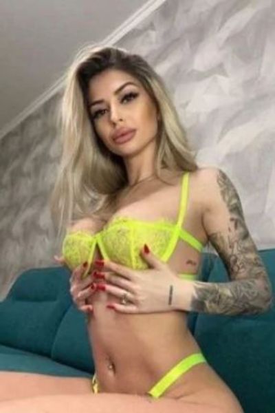 Party Girl Sierra in yellow lingerie showing tattoos