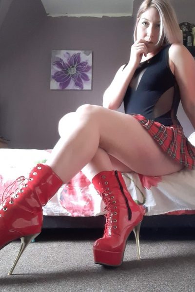Miss Nee in red leather heeled boots