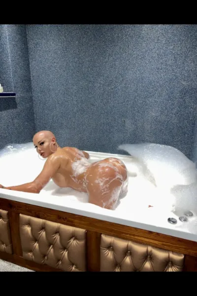 TS Jordy Doll laid in a huge indoor hottub naked