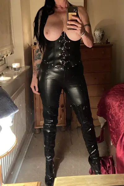 Topless Bridgend escort in leather outfit and boots