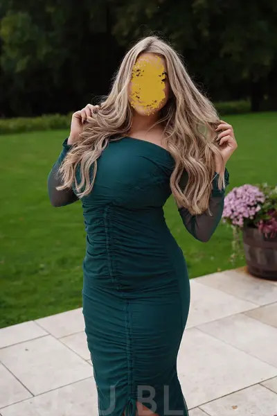 British escort in a tight green dress