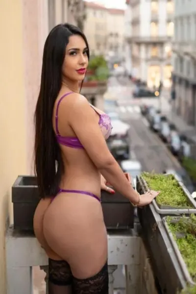 Manchester escort in purple lingerie on a balcony