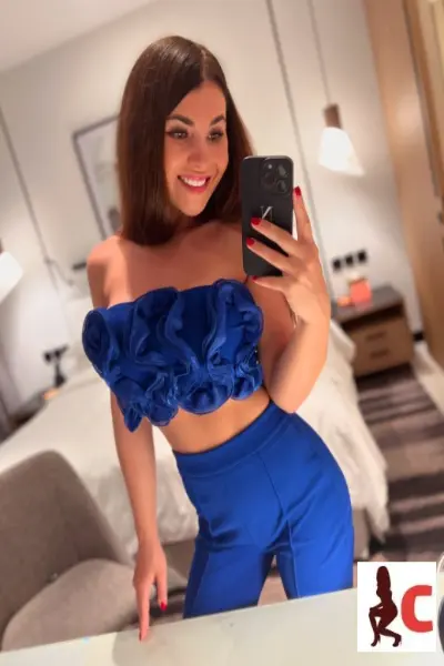 Smiling Czech escort in blue outfit