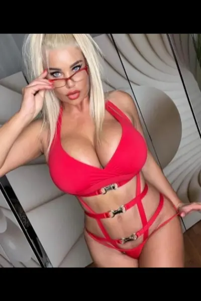 Blonde Hammersmith Escort in strappy red lingerie