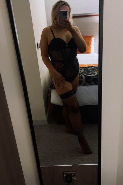 Curvy blonde escort taking a selfie